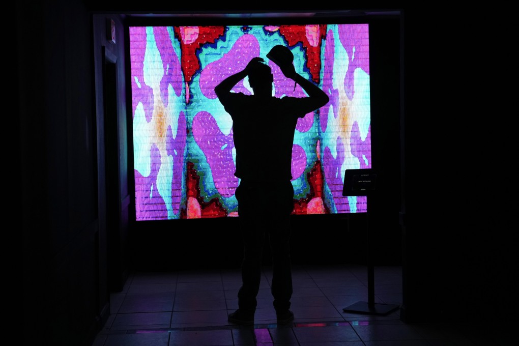 A man looks at an NFT by artist Jen Stark at a festival called The Gateway: A Web3 Metropolis during Miami Art Week on November 30. Photo: AP
