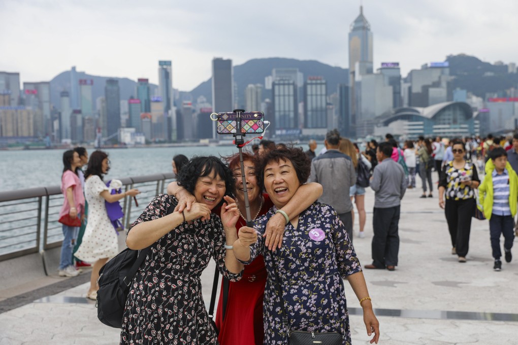 Tourists share a light moment at the Avenue of Stars on the Tsim Sha Tsui promenade in Hong Kong during the mini-golden week holiday on the mainland on May 2, 2019. Photo: Sam Tsang