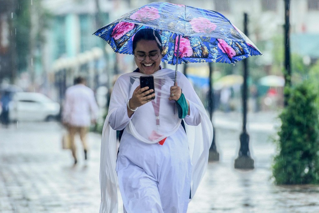 A commuter checks her mobile phone in Srinagar, India. Photo: AFP