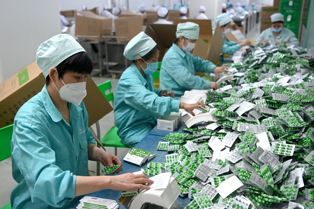 Employees pack medicines at a pharmaceutical company in northwest China amid a surge in demand for drugs to ease Covid-19 symptoms. Photo: Xinhua