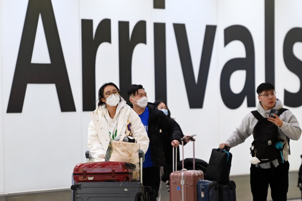 People travelling from China arrive at Heathrow Airport. After China last month allowed outbound travel for its citizens, several countries said travellers from China must present a negative Covid-19 test taken within the previous 48 hours, and be subject to random testing on arrival. Photo: EPA-EFE