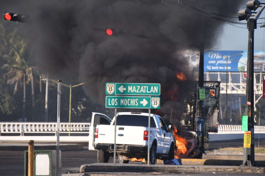 Burning vehicles block a road after drug lord Ovidio Guzman’s capture, in Culiacan, Sinaloa, Mexico on Thursday. Photo: Revista Espejo / Leo Espinoza / Handout via Reuters