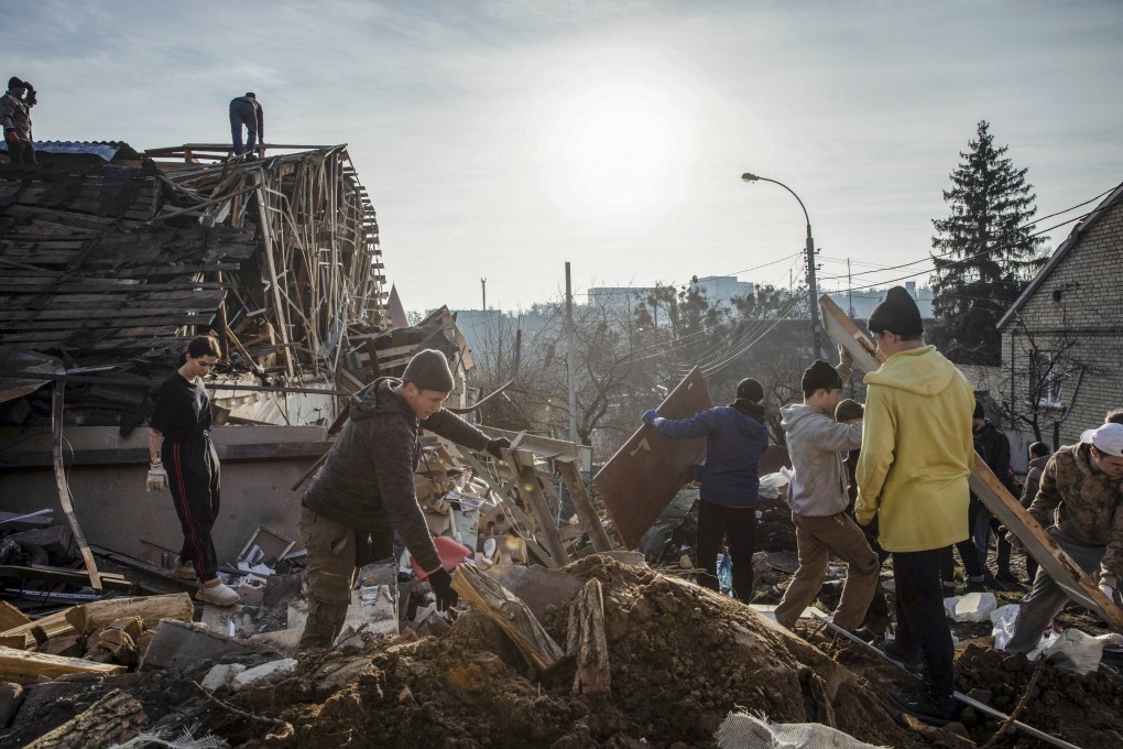 Volunteers remove debris on Tuesday from the site of a Russian missile attack in Kyiv. Photo: EPA-EFE