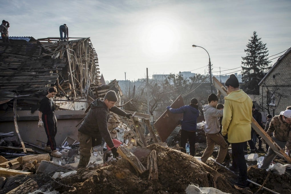 Volunteers remove debris on Tuesday from the site of a Russian missile attack in Kyiv. Photo: EPA-EFE
