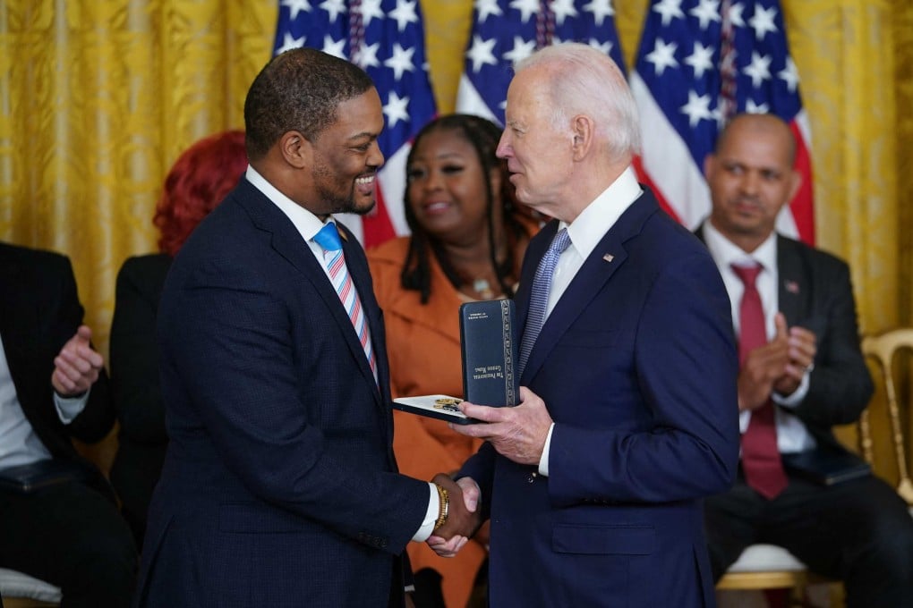 US President Joe Biden awards the Presidential Citizens Medal to Capitol Police Officer Eugene Goodman during a ceremony marking the second anniversary of the January 6, 2021 attack on the US Capitol on Friday. Photo: AFP,