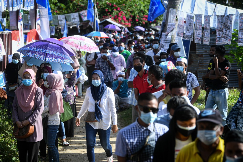 People queue outside a polling station to cast their vote during the 2020 Sabah state election. File photo: BERNAMA/dpa