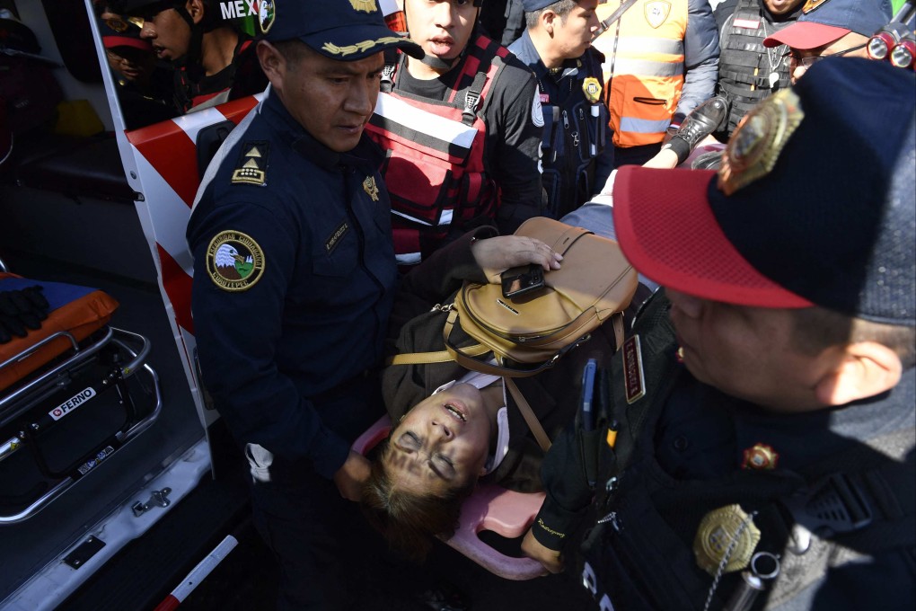 An injured woman is taken out of the Indios Verdes metro station after two trains collided in Mexico City, Mexico on Saturday. Photo: AFP)