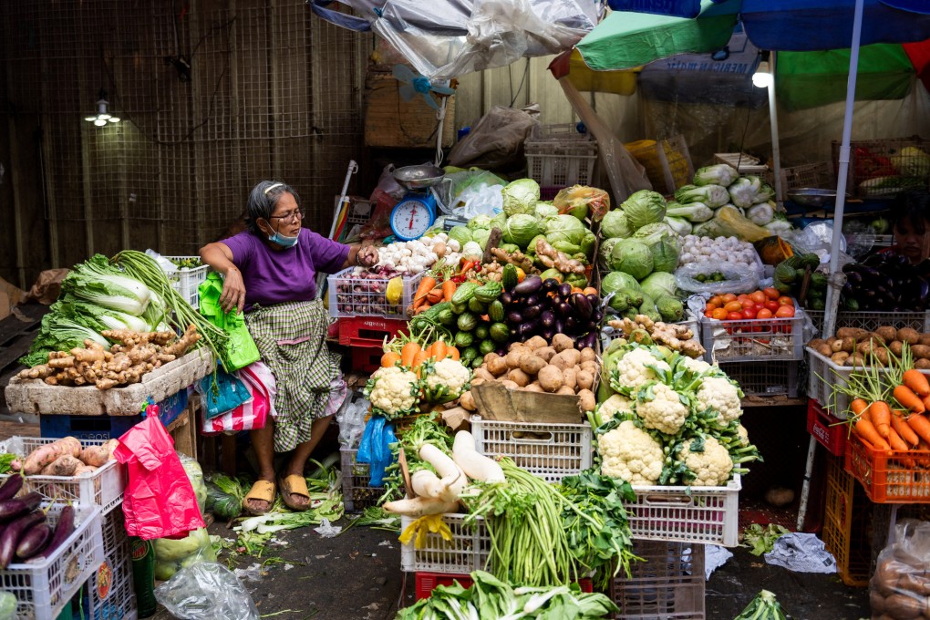 A vegetable vendor tends to her store at a public market in Manila last month. Onion prices in the Philippines have been pushed higher by a drop in local output. Photo: Reuters