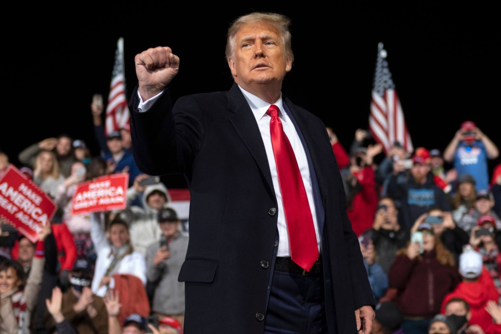 US President Donald Trump holds up his fist as he leaves the stage at the end of a rally in Valdosta, Georgia, in December 2020. Photo: AFP via TNS