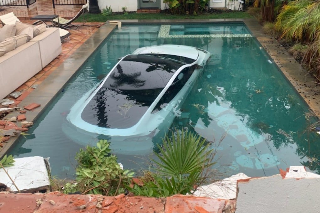A Tesla driver hit the accelerator instead of the brake, drove through a wall and into a pool. Photo: Handout/Pasadena Fire Dept