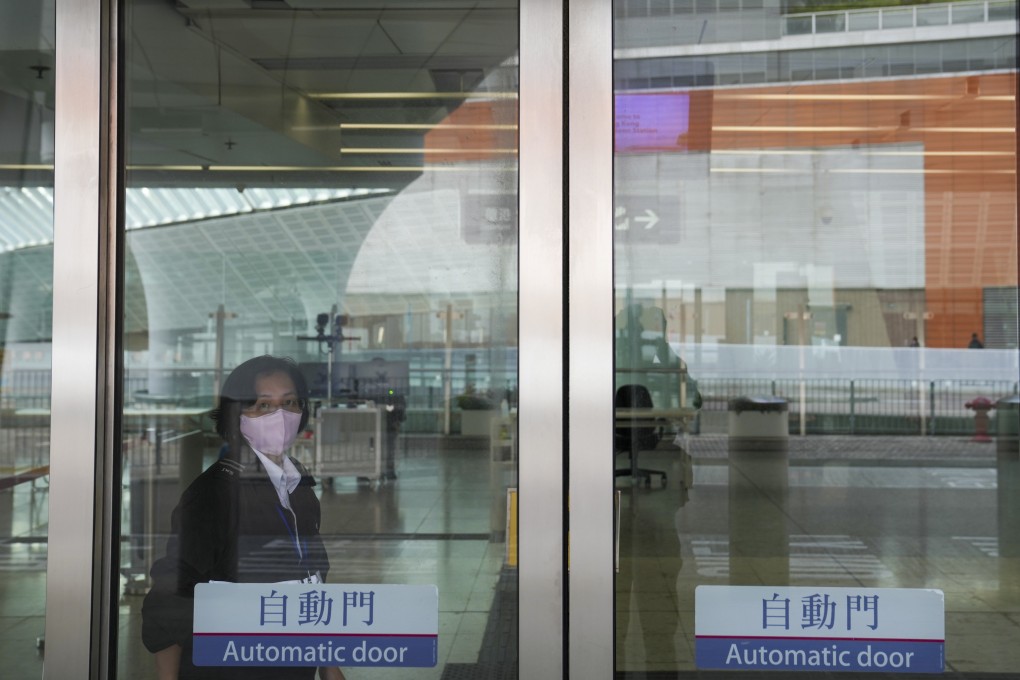 A security guard on duty at Hong Kong West Kowloon Railway Station. Some 46,000 to 87,000 workers, mostly security guards and cleaners, will benefit when the city’s new wage floor comes into effect in May. Photo: Sam Tsang
