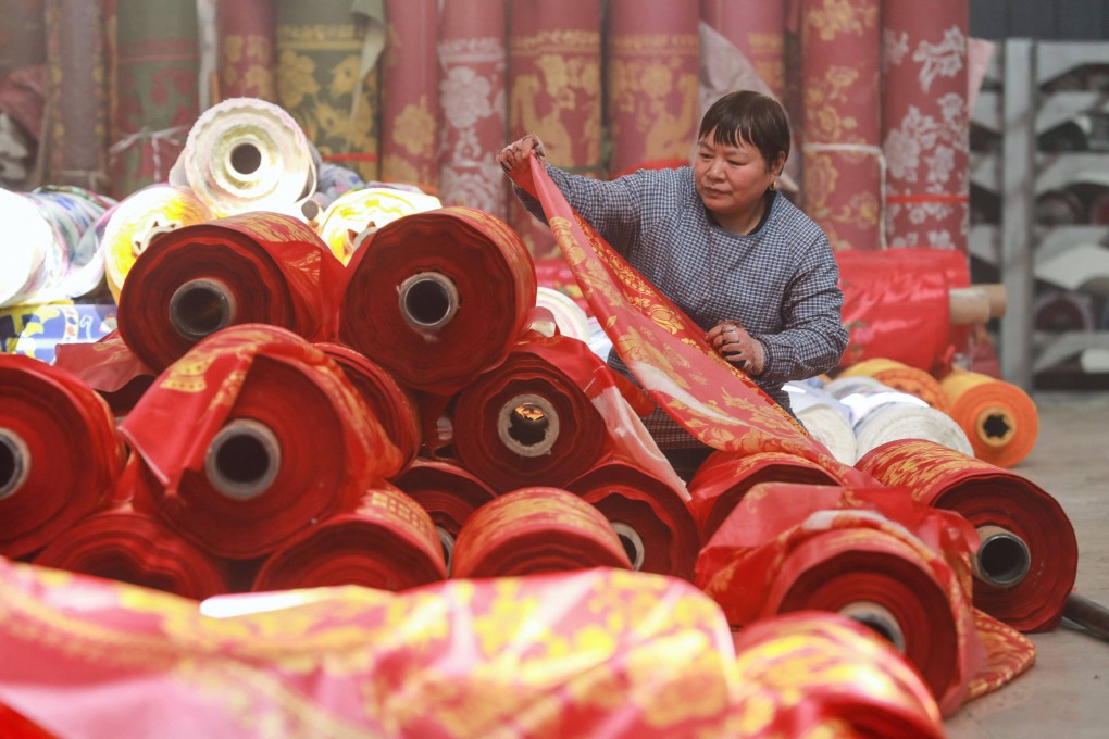 A worker checks cloth at a textile factory in China’s Zhejiang province, where authorities say they will “exhaust all measures to push for export growth” this year. Photo: AFP
