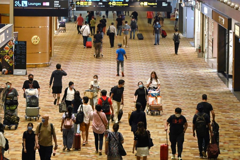 Travellers walk through a transit hall of Changi airport in Singapore. Photo: AFP