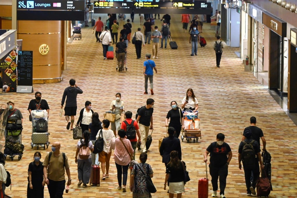 Travellers walk through a transit hall of Changi airport in Singapore. Photo: AFP