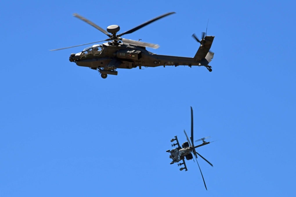 Apache attack helicopters are outfitted with laser systems to defend against missiles. Photo: AFP