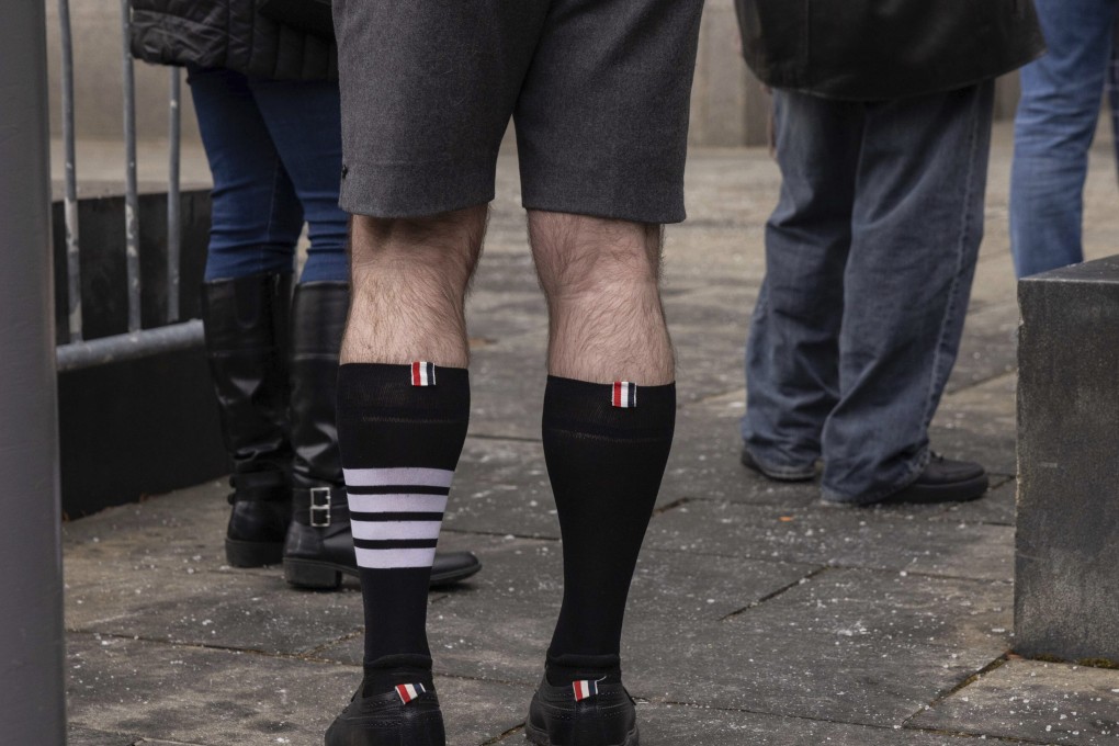 Fashion designer Thom Browne wears socks from his label with four stripes outside a federal court in Manhattan, New York, that was hearing Adidas’ case against his brand over use of the stripes. A jury found in his favour on Thursday. Photo: AP