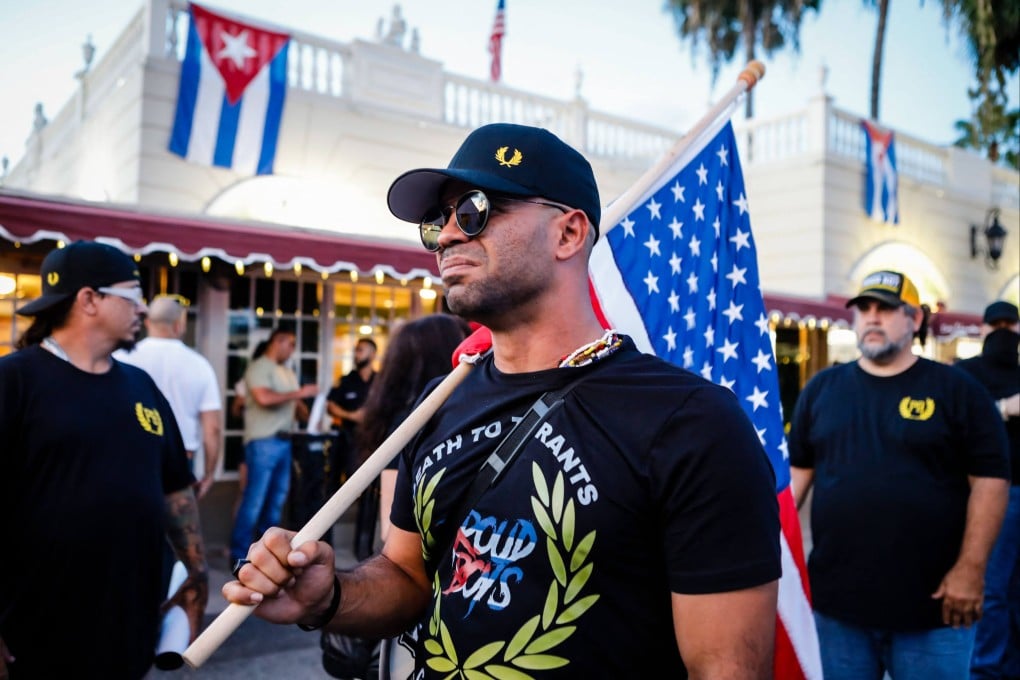 Henry “Enrique” Tarrio, leader of The Proud Boys, holds a US flag during a protest in Miami, Florida, in July 2021. Photo: TNS