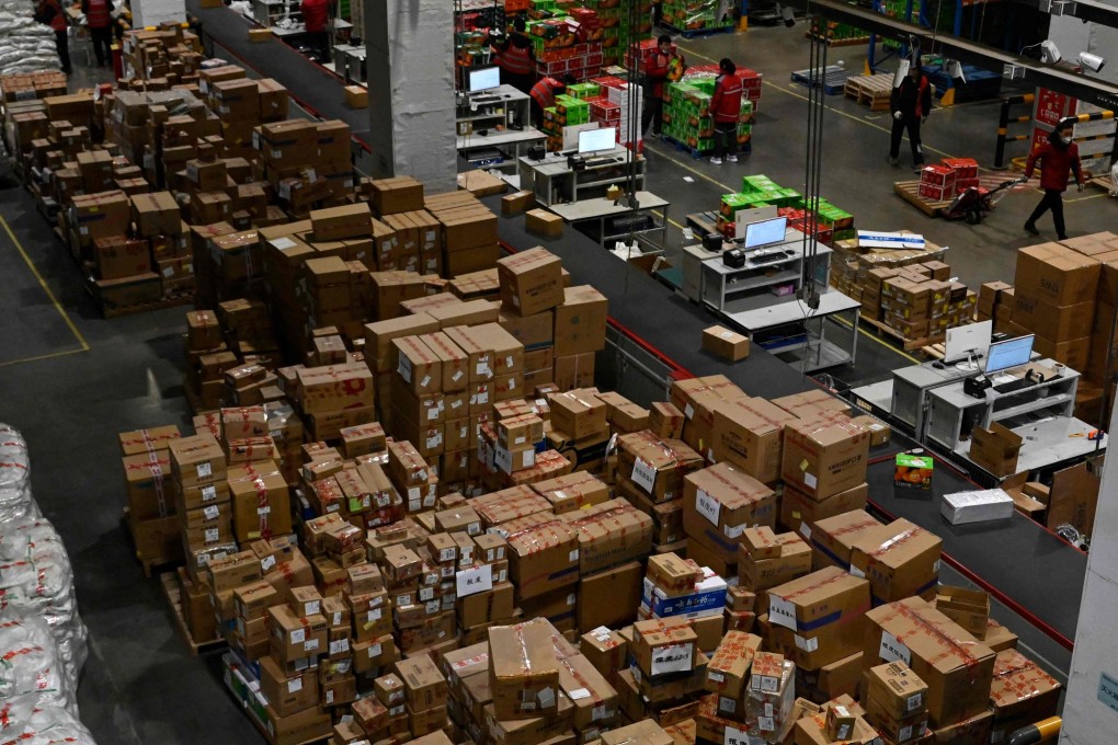 Workers sort packages for delivery at a JD.com warehouse in Beijing on January 10. With further fiscal and monetary support, China’s economy should see a stronger rebound in the second half of the year. Photo: AFP