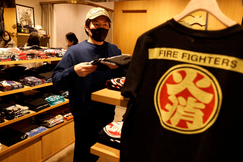 Sales manager Masaki Nagayama works at his store, a clothes shop featuring Japanese firefighter organisation of the Edo era.The Japanese government is considering no longer asking the public to wear masks indoors in principle unless they have symptoms. Photo: Reuters