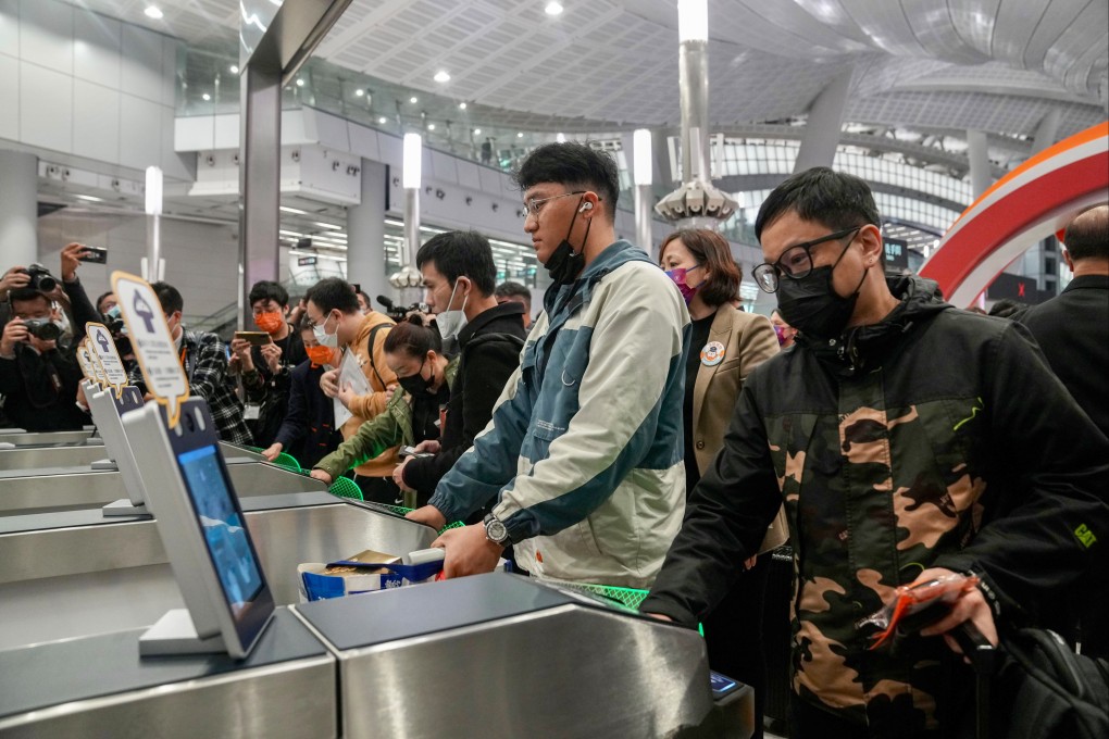 Passengers pass clearance for the first outbound trains to Guangzhou. Photo: Sam Tsang