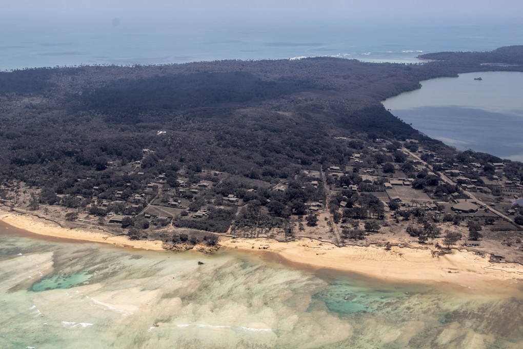 Volcanic ash covers roof tops and vegetation in an area of Tonga in January 2022, days after the eruption of the underwater Hunga Tonga-Hunga Ha’apai volcano. Photo: NZDF via AP