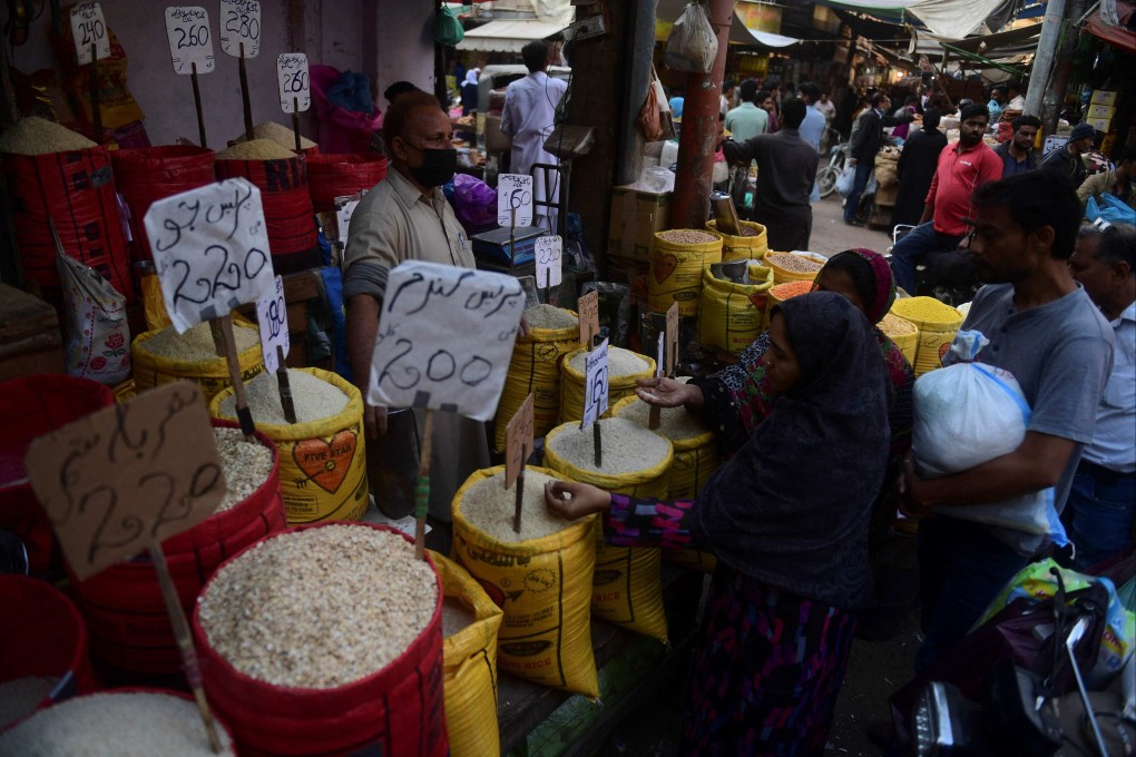 People buy grocery items at a main wholesale market in Karachi. Pakistan’s enormous national debt currently stands at 90 per cent of gross domestic product. Photo: AFP