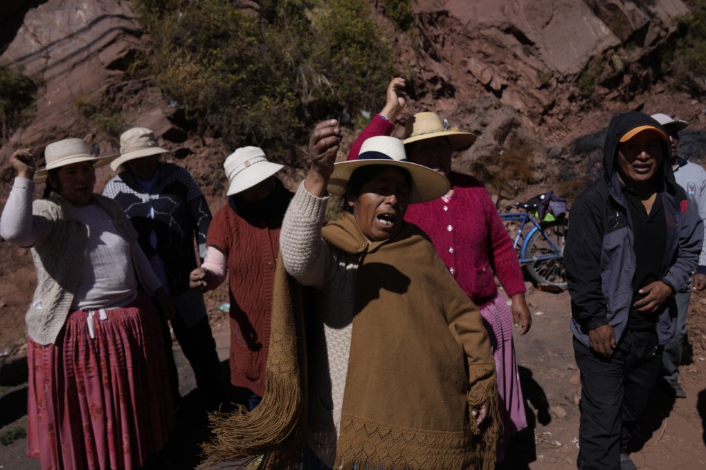 Protesters shout “Murderous Dina resign!” referring to Peruvian President Dina Boluarte, as they block the border in Desaguadero, Peru, near Bolivia, on Friday. Photo: AP