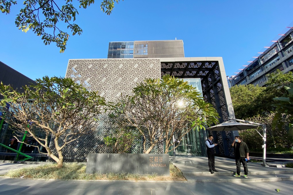Men stand outside the headquarters of Chinese developer Fantasia Holdings in Shenzhen, Guangdong province, China on November 10, 2021. Photo: Reuters