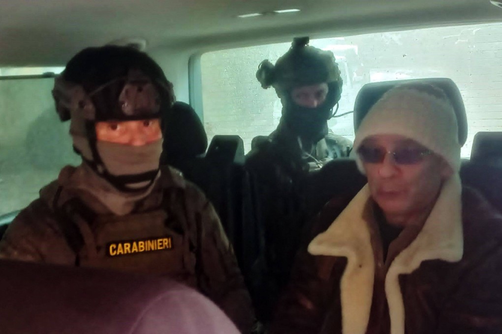 This handout picture released on January 16, 2023 by the Ufficio Stampa Comando Generale Carabinieri shows Italy’s top wanted mafia boss, Matteo Messina Denaro (right), being escorted in a vehicle by carabinieri after he was arrested in his native Sicily after 30 years on the run. Photo: AFP
