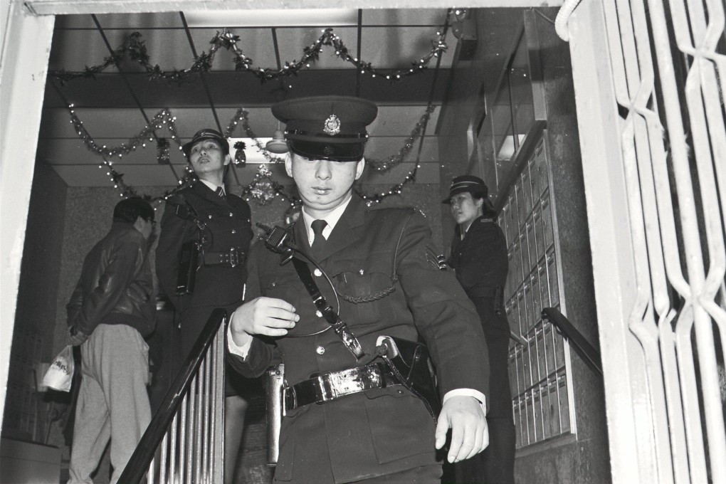 A police officer leaves the building where Hong Kong journalist Chan Kang-nan was found dead. Photo: SCMP