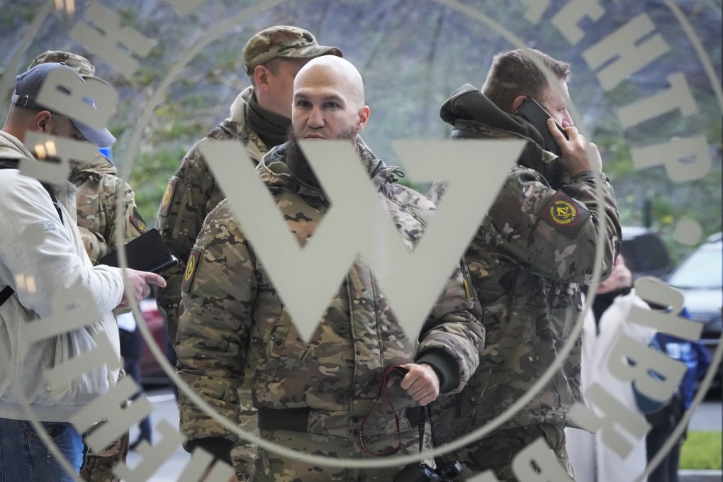 Men in military camouflage gear stand at the entrance of Russia’s “PMC Wagner Centre” which is associated with Yevgeny Prigozhin, businessman and founder of the Wagner military group. File photo: AP