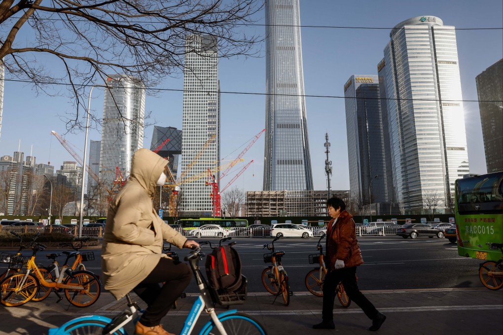 People walk travel on a road in the central business district of Beijing on January 17, 2023. China’s economy expanded by 3 per cent in 2022, according to the country’s National Bureau of Statistics. Photo: EPA-EFE