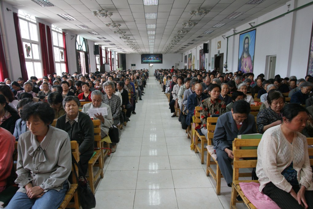 Chinese Christians pray at a state-sanctioned Catholic Church in Xining, China. A Protestant church founded in Shanghai in the 1920s continues to operate underground in China - and openly in the United States, where it recruits arriving Chinese migrants. Photo: China Photos/Getty Images