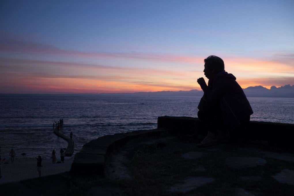 A tourist taking in the sunset at Green Island in Taitung. Photo: Xinhua