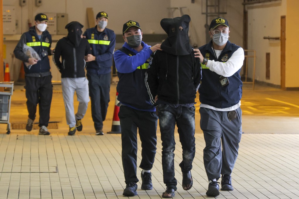 Customs officers arrest two men on suspicion of attempting to smuggle 74,000 pills believed to be used to treat Covid-19 into the city. Photo: Jelly Tse