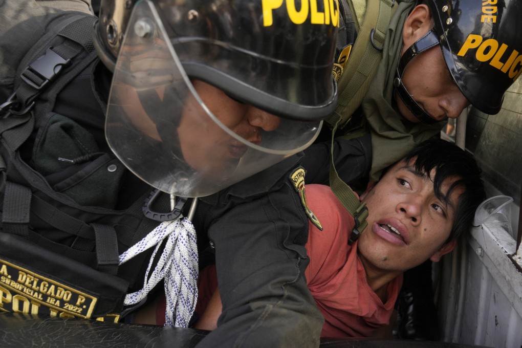 Police detain a person during anti-government clashes in Lima, Peru. Photo: AP