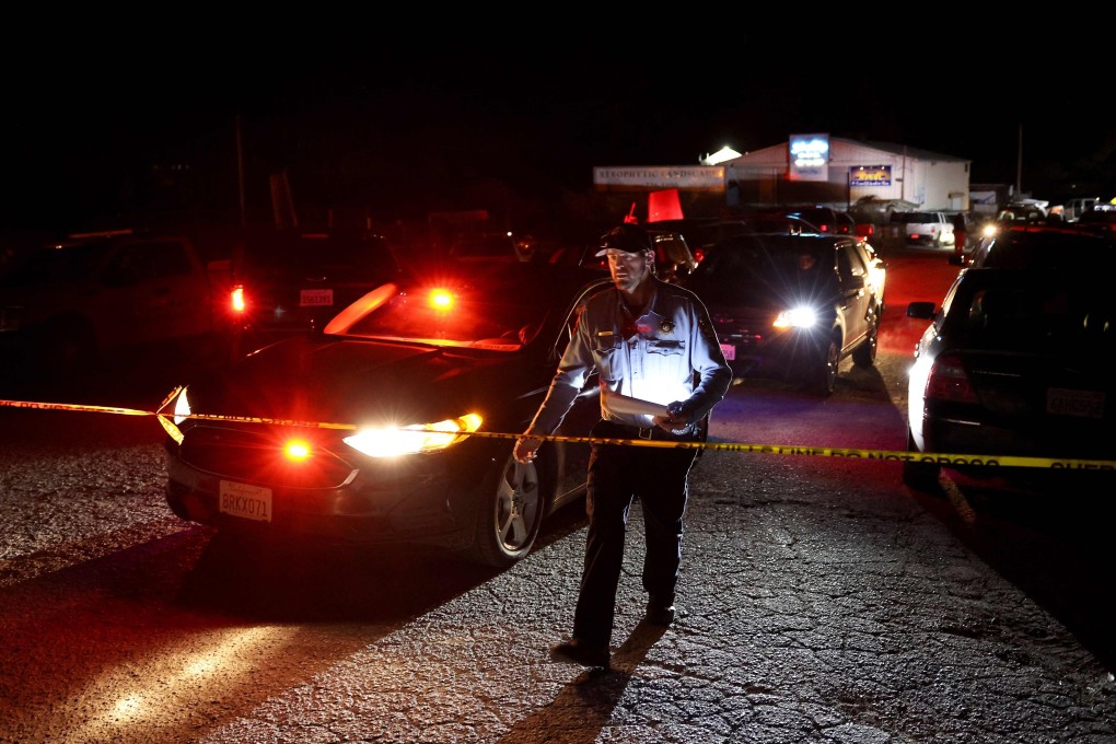A police officer walks towards police tape as US officials conduct an investigation into a mass shooting in Half Moon Bay, California. Seven people were killed at two separate farm locations on Monday. Suspect Chunli Zhao was taken into custody a few hours later. Photo: via AFP