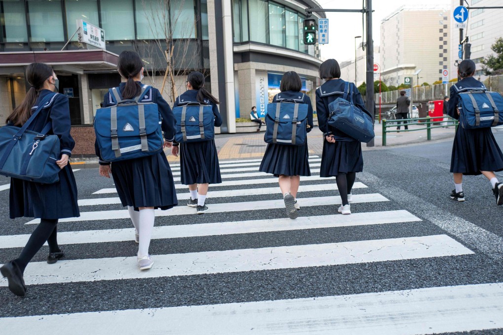 Students returning home from school in Tokyo. chools across Japan received threats that students and teachers would be “murdered”. Photo: AFP