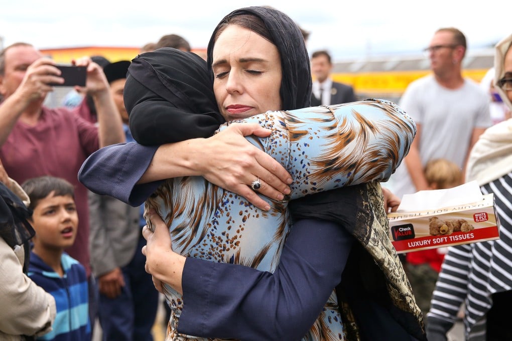 Prime Minister Jacinda Ardern, wearing a hijab, comforts a woman in the days after 2019’s Christchurch mosque shootings. Photo: Getty Images