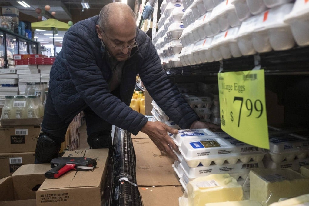 A worker stocks eggs on a shelf at a grocery store in Detroit, Michigan, on January 18. While egg prices remain stubbornly high, other price rises are easing, a sign that inflation may have peaked. Photo: Bloomberg