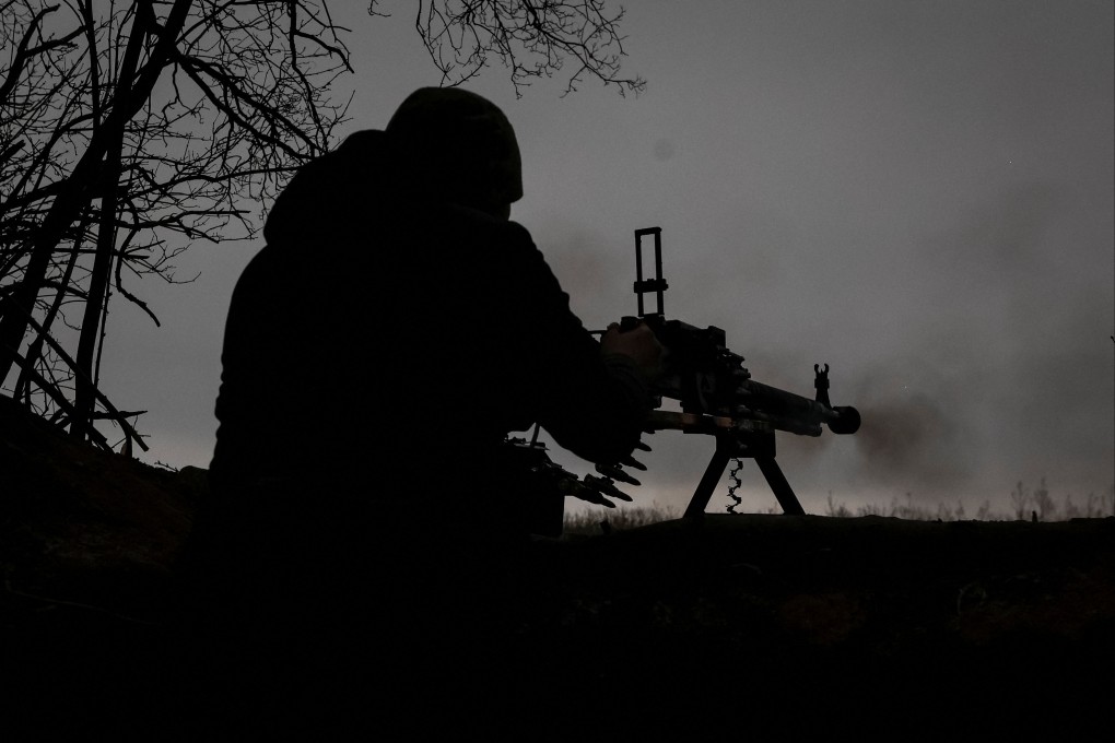 A Ukrainian service member fires a machine gun at a position on the front line near the town of Soledar on January 14. Photo: Radio Free Europe/Radio Liberty via Reuters