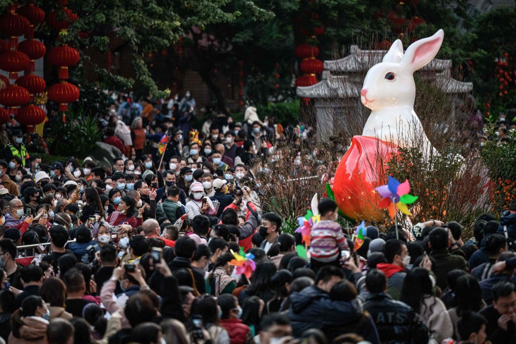 People visit a traditional Spring Festival flower market in Guangzhou on January 20. China’s reopening and the prospect of unleashing years of pent-up consumer demand have turned markets bullish, but the strength and durability of China’s upturn remains in doubt. Photo: AFP