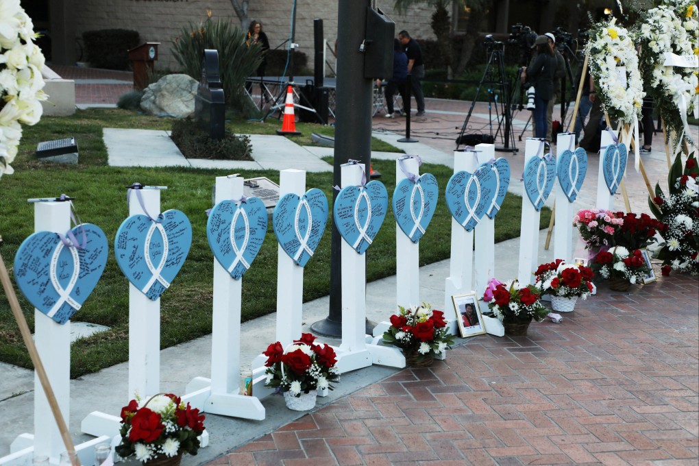 The names of the 11 people killed during a Lunar New Year shooting in California are written on hearts as people gather for a candlelight vigil. Photo: Reuters