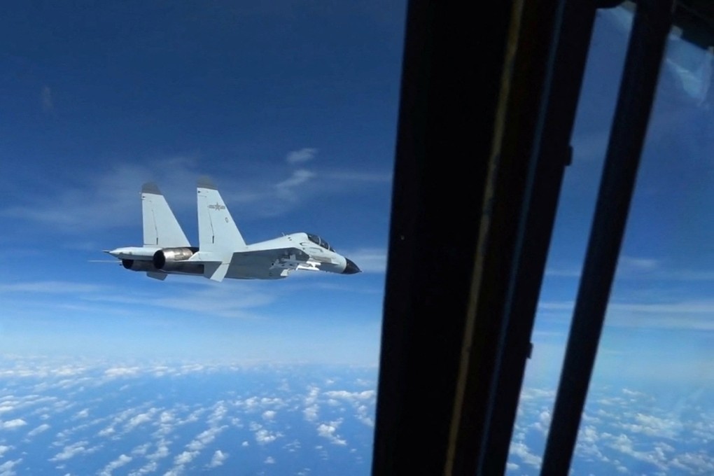 A PLA Navy J-11 fighter jet flies close to a US Air Force RC-135 surveillance plane over the South China Sea on December 21. Photo: Handout