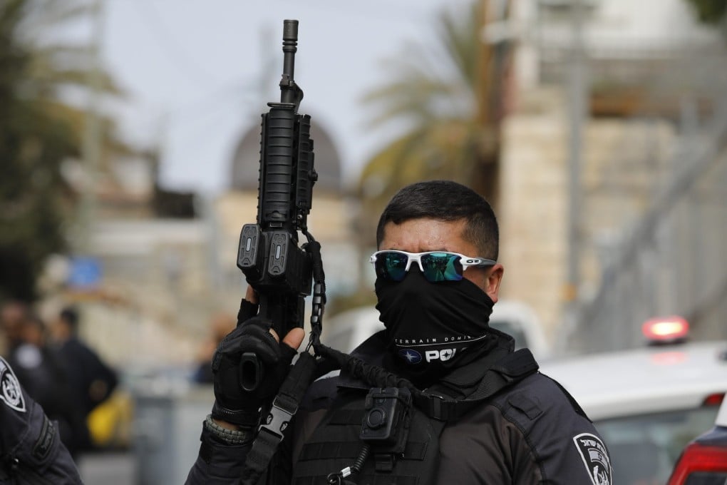 A police officer closes the area in Jerusalem where two Israeli’s were shot and wounded a day after deadly attack on a synagogue. Photo: dpa