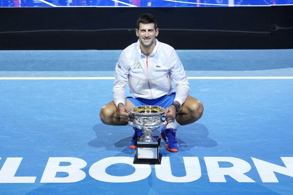 Novak Djokovic poses for pictures after claiming his 10th title at the Australian Open. Photo: Kyodo