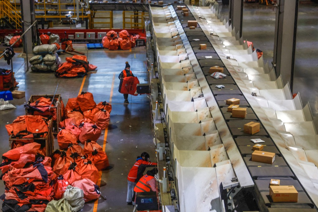 Employees check packages during an organised media tour at JD Logistics’ Asia No 1 logistics centre in Beijing on January 10, 2023. JD.com is closing its local platforms for Thailand and Indonesia to better focus on its supply chain and logistics strengths after setbacks from regional competition. Photo: Reuters