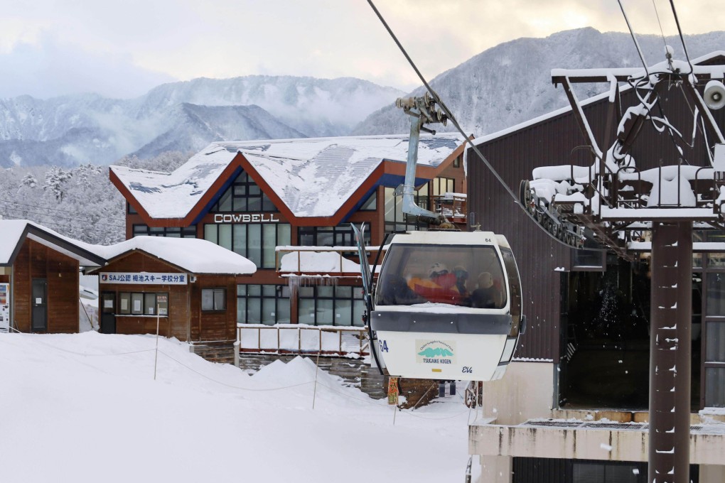 Rescuers ride a ski lift at a resort in the village of Otari, central Japan’s Nagano prefecture, on Monday as they take part in the search for the missing skiers. Photo: Kyodo