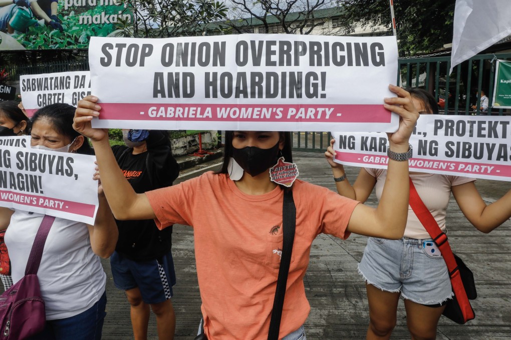 Protesters hold signs during a demonstration calling for government action to reduce food prices outside the Philippine Department of Agriculture in Quezon City earlier this month. Photo: EPA-EFE