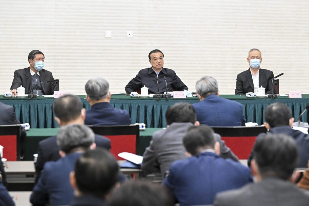 He Lifeng (pictured on left), is seen seated alongside Premier Li Keqiang at a symposium on Monday. Photo: Xinhua